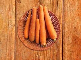 Carrots On The Wooden Background photo