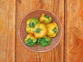 Peppers On The Wooden Background photo