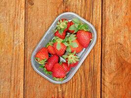 Strawberries On Wooden Background photo