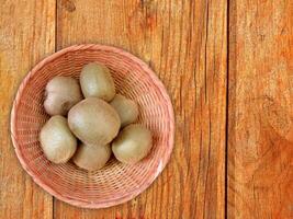 Kiwi On Wooden Background photo