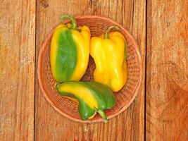 Peppers On The Wooden Background photo