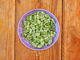 Broad Beans On Wooden Background photo