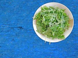 Arugula On Wooden Background photo