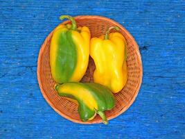 Peppers On The Wooden Background photo