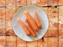 Carrots On The Wooden Background photo