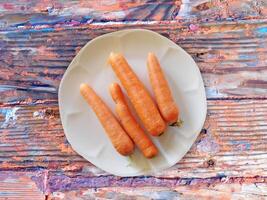 Carrots On The Wooden Background photo