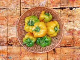 Peppers On The Wooden Background photo