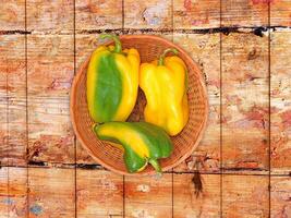 Peppers On The Wooden Background photo