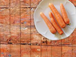 Carrots On The Wooden Background photo