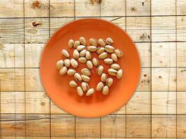 Pistachios On The Wooden Background photo