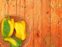 Peppers On The Wooden Background photo