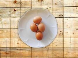 Eggs On The Wooden Background photo
