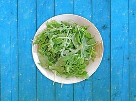 Arugula On Wooden Background photo