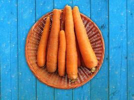 Carrots On The Wooden Background photo