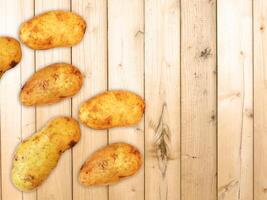 Potatoes On The Wooden Background photo