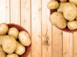 Potatoes On The Wooden Background photo