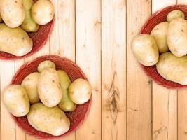 Potatoes On The Wooden Background photo