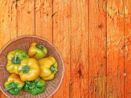 Peppers On The Wooden Background photo