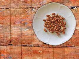 Almonds On Wooden Background photo