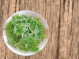 Arugula On Wooden Background photo