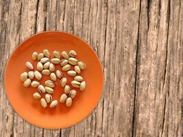 Pistachios On The Wooden Background photo