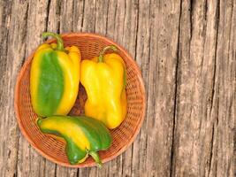 Peppers On The Wooden Background photo