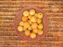 Apricots On The Wooden Background photo