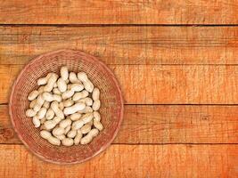 Peanuts On The Wooden Background photo