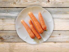 Carrots On The Wooden Background photo