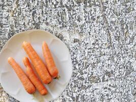 Carrots On The Wooden Background photo