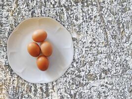 Eggs On The Wooden Background photo