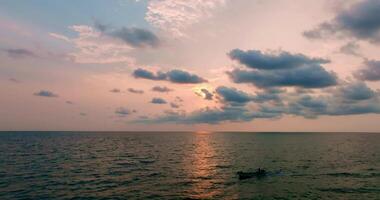 Aerial drone view of clear turquoise sea and waves over the ocean with sunset video