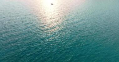 Aerial drone view of clear turquoise sea and waves over the ocean video