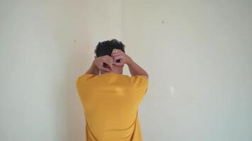 Young Indonesian curly man wear yellow t-shirt depression gesture and expression.  The footage is suitable to use for man expression and people advertising content media. video