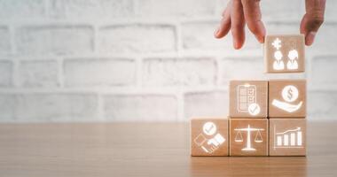 IPO concept, Hand holding wooden block on desk with IPO icon on virtual screen. photo