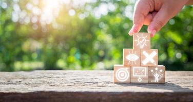 Creativity concept, Hand holding wooden block on desk with creativity icon on virtual screen. photo