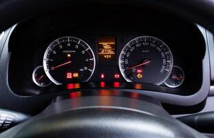 Analog dashboard car with colorful light status symbol photo