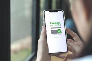 Online financial transactions and payment successful. Close-up of hand using smartphone for payment of shopping transaction By credit card online banking photo