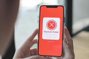 Payment failed, declined. Red online financial transaction notification in application showing error on smartphone. Concept of online banking, encrypting transactions and secure connection. photo