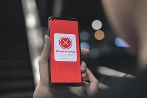 Payment failed, declined. Red online financial transaction notification in application showing error on smartphone. Concept of online banking, encrypting transactions and secure connection. photo