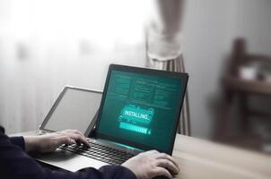 Installing security programs and adding modern functions to improve applications. Programmer installs new software on laptop photo