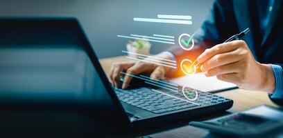 Business performance checklist, businessman using laptop doing online checklist survey, Check marks on checklist and Filling online form or answering questions. evaluation, online survey, online exam. photo