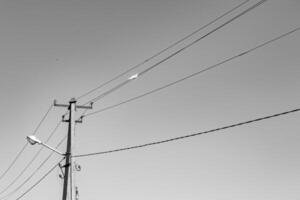 Power electric pole with line wire on light background close up photo