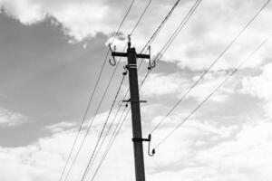 Power electric pole with line wire on dark background close up photo