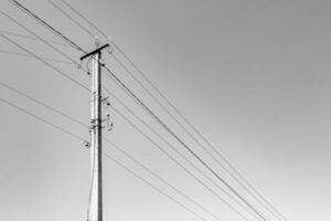 Power electric pole with line wire on light background close up photo