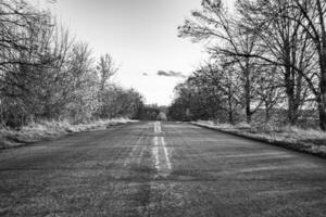 Beautiful empty asphalt road in countryside on colored background photo