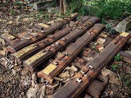 piles of scrap iron which are usually used to make train tracks are lying in the train station area photo