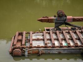 iron floating in a small lake, looks a lot of rust and rubbish photo