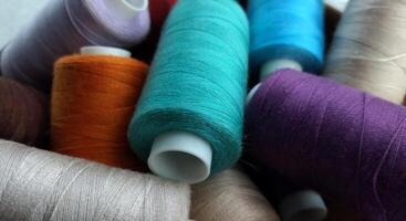 Rolls of multi-colored threads for tailors working in the garment embroidery sector photo