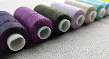 Rolls of multi-colored threads for tailors working in the garment embroidery sector photo